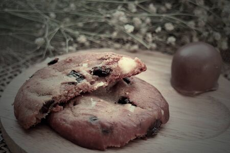 Cookies  chocolate cheese on wooden platesの写真素材