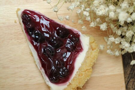 Blueberry cheese cake on wooden platesの写真素材
