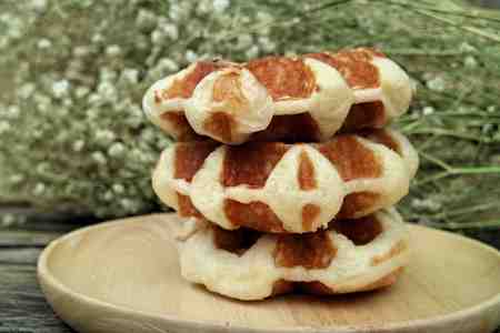 waffle and chocolate sauce on wooden platesの写真素材