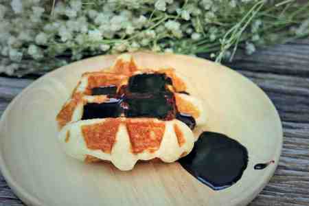 waffle and chocolate sauce on wooden plates