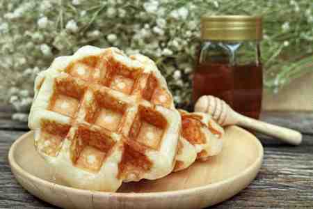 waffle and chocolate sauce on wooden plates