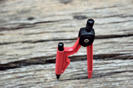 compasses red on wooden background
