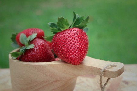 Fresh and ripe strawberries on a wooden backgroundの写真素材
