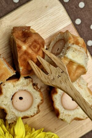 Waffle hotdog on wooden  plates