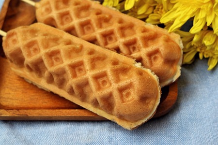Waffle hotdog on wooden  platesの写真素材