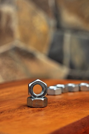 nut arrange as a heart on wood background