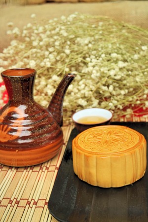 Traditional mooncakes and tea on table with teacup, Retro vintage style Chinese mid autumn festival foodsの写真素材