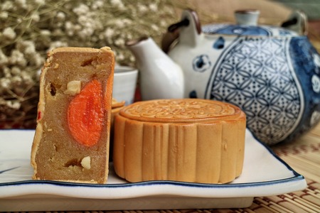Traditional mooncakes and tea on table with teacup, Retro vintage style Chinese mid autumn festival foodsの写真素材