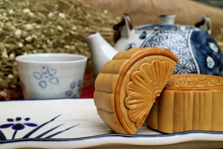 Traditional mooncakes and tea on table with teacup, Retro vintage style Chinese mid autumn festival foodsの写真素材