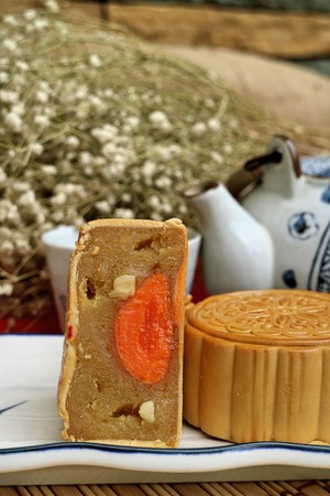 Traditional mooncakes and tea on table with teacup, Retro vintage style Chinese mid autumn festival foodsの写真素材