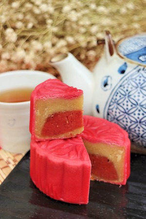 Traditional mooncakes and tea on table with teacup, Retro vintage style Chinese mid autumn festival foodsの写真素材