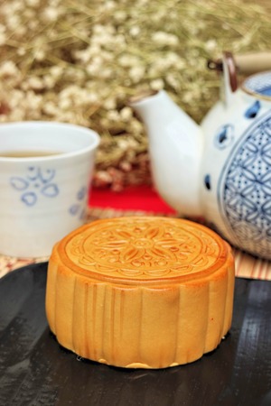 Traditional mooncakes and tea on table with teacup, Retro vintage style Chinese mid autumn festival foodsの写真素材