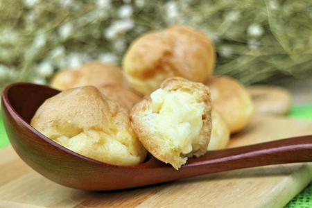 Eclair cream on a wooden plates