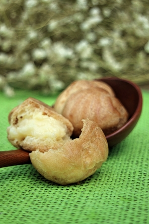 Eclair cream on a wooden plates