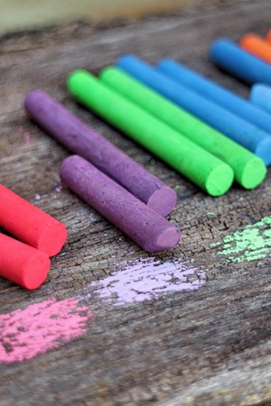 Colored Chalk on old wood background