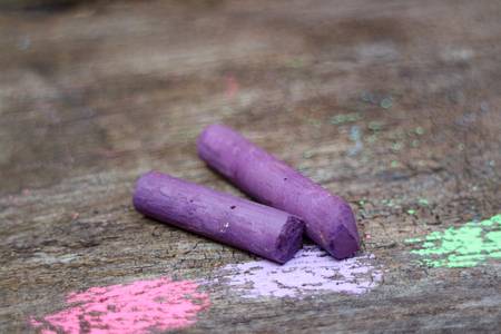 Colored Chalk on old wood background