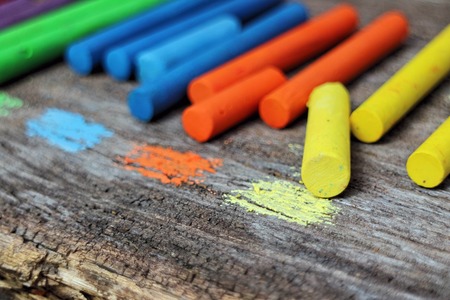 Colored Chalk on old wood backgroundの写真素材