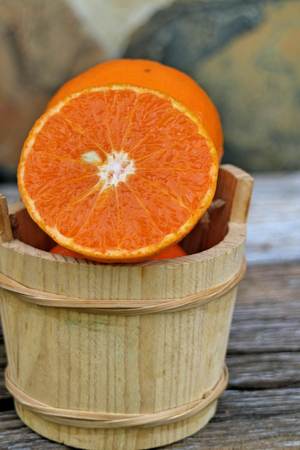 Fresh oranges on the wooden backgroundの写真素材