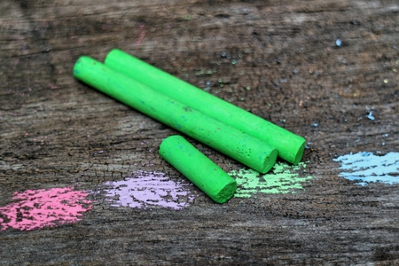 Colored Chalk on old wood backgroundの写真素材
