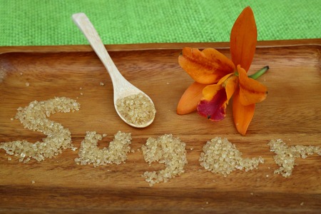 Brown sugar crystals on wood backgroundの写真素材