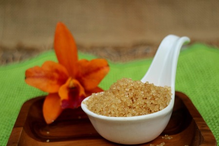 Brown sugar crystals on wood backgroundの写真素材