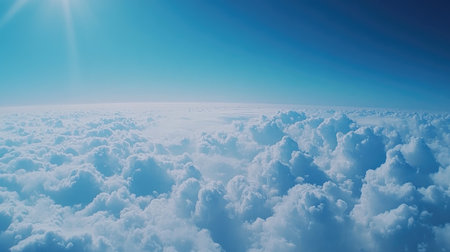 High-altitude view of clouds from above, with a bright blue sky creating a sense of freedom and space.の素材