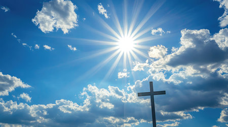 Cross with angelic rays in a bright sky, ideal for uplifting and comforting messagesの素材