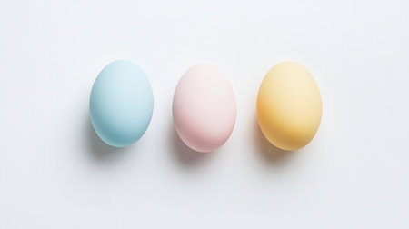 This image features three pastel eggs in blue, pink, and yellow placed on a clean white background, perfect for spring themes, Easter celebrations, and festive decorations.の素材
