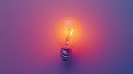 A vintage light bulb emits a warm glow, creating a calming atmosphere against a soft purple background, ideal for modern decor and inspiring creativity in design projects.の素材
