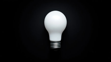 A striking image of a LED light bulb on a dark backdrop, emphasizing simplicity and modern aesthetics, perfect for projects related to design and innovation.の素材