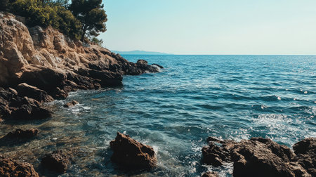 Discover a stunning coastal landscape featuring rocky shores and clear blue waters, perfect for anyone seeking tranquility and natural beauty under a bright sky.の素材