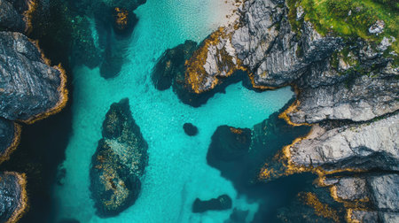 Aerial view of the Isle of Skyes Fairy Pools, with clear blue waters cascading down multiple levels of waterfalls. No people included.の素材
