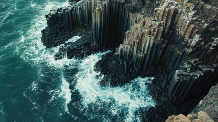 Aerial view of the Giant's Causeway coastline, with the unique basalt columns meeting the churning sea below. No people included.の素材