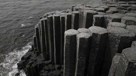 The striking patterns of the basalt columns at the Giant's Causeway, with their natural symmetry set against the Atlantic Ocean. No people included.の素材