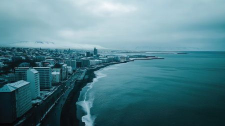 Aerial shot of Reykjaviks coastal skyline, with the deep blue North Atlantic Ocean meeting the vibrant cityscape. No people included.の素材
