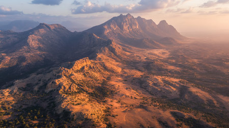 Aerial view of the mystical landscape of Socotra Island during the golden hour, with warm light illuminating the unique terrain. No people included.の素材