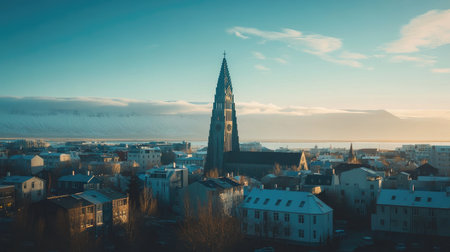 Panoramic shot of Reykjavik cityscape, with the distinct church and the mountains framing the horizon. No people included.の素材