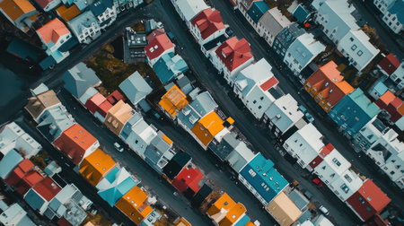 Aerial shot of Reykjaviks city center, highlighting the colorful rooftops, iconic landmarks, and the surrounding natural beauty. No people included.の素材
