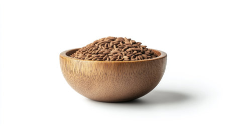 Close-up of aromatic cumin seeds in a small wooden bowl, their earthy texture highlighted on a clean white backgroundの素材