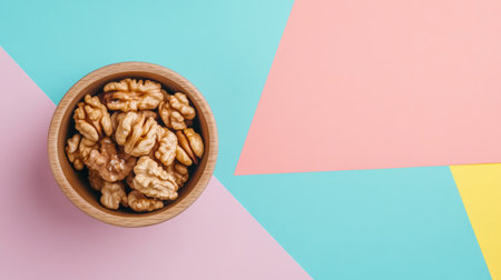 A wooden bowl of walnut halves placed on a colorful background, emphasizing healthy eating and the superfood benefits of walnuts, with room for textの素材