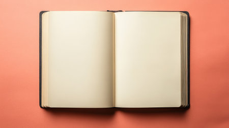 Blank sketchbook open on a bright, vibrant background, top view with clean, uncluttered space perfect for creative or promotional contentの素材