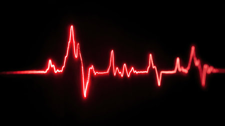 A striking visual of a red heartbeat waveform against a black background, symbolizing vital signs and health monitoring in medical contexts and graphic designs.の素材