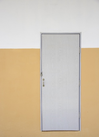Grey doors on orange wall and white wall backgroundの写真素材