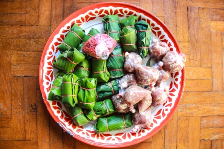 Sour pork : Thai northeastern style food which mixed pork rice garlic  and salt in banana leaf package and plastic packageの写真素材