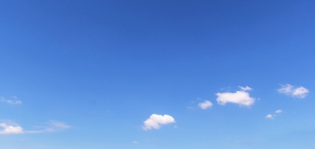 Fantastic soft white clouds against blue skyの写真素材