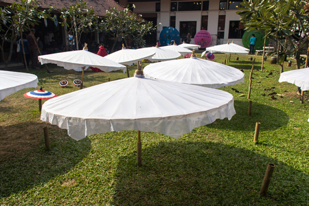 Thailand, Chiang Mai, hand painted Thai umbrellas drying in the sun outside an umbrella factoryのeditorial素材