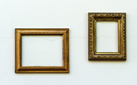 Vintage golden frame on old and dirty gray concrete wallの写真素材