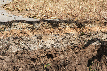 soil under the asphalt road collapsed from water erosionの写真素材
