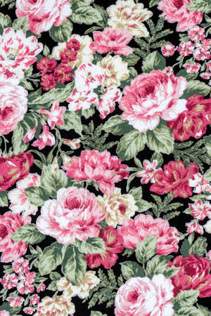 Red rose on black fabric background, Fragment of colorful retro tapestry textile pattern with floral...