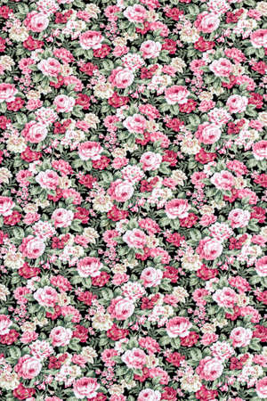 Red rose on black fabric background, Fragment of colorful retro tapestry textile pattern with floral ornament useful as background.の写真素材